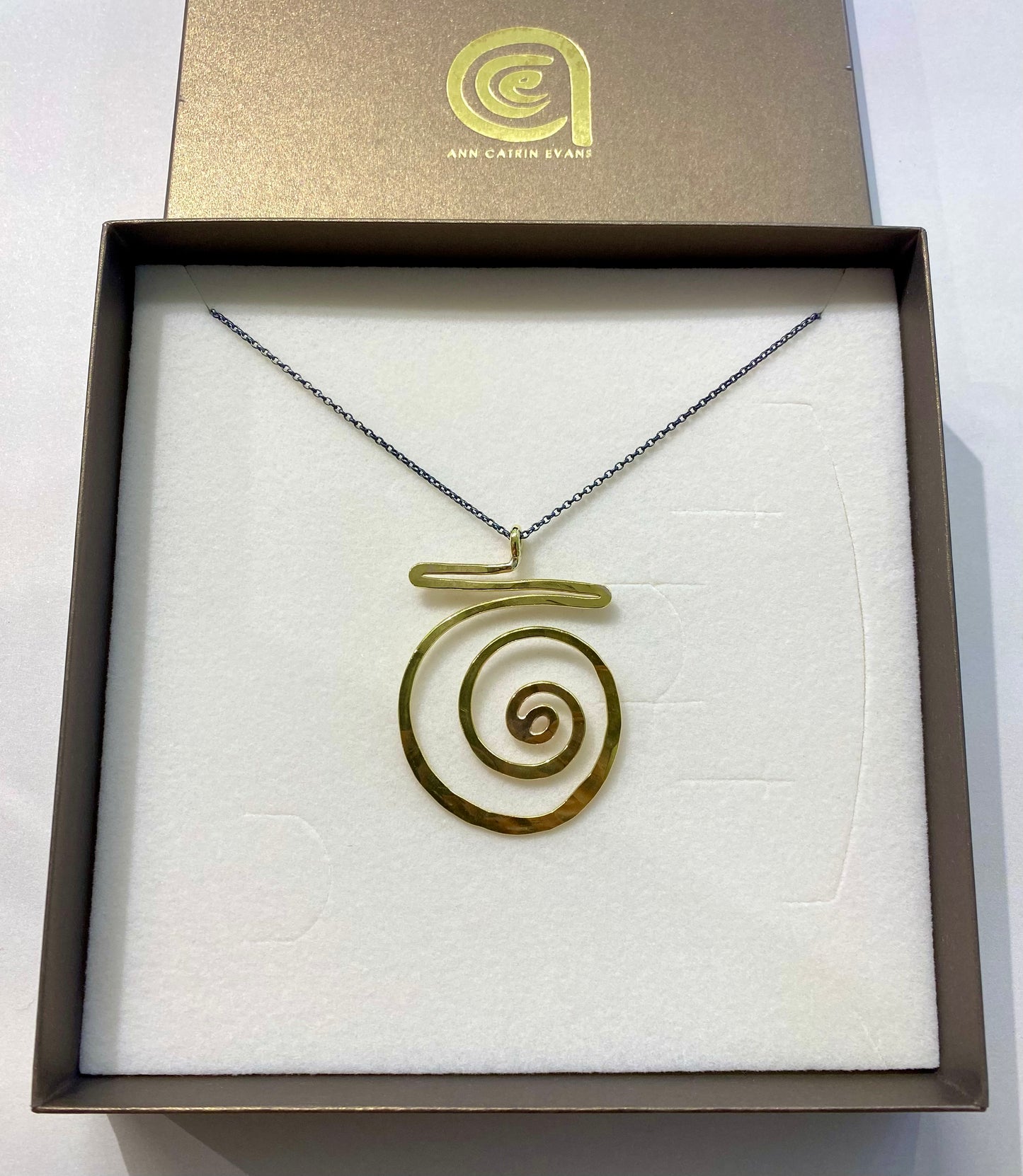 Brass swirl pendant