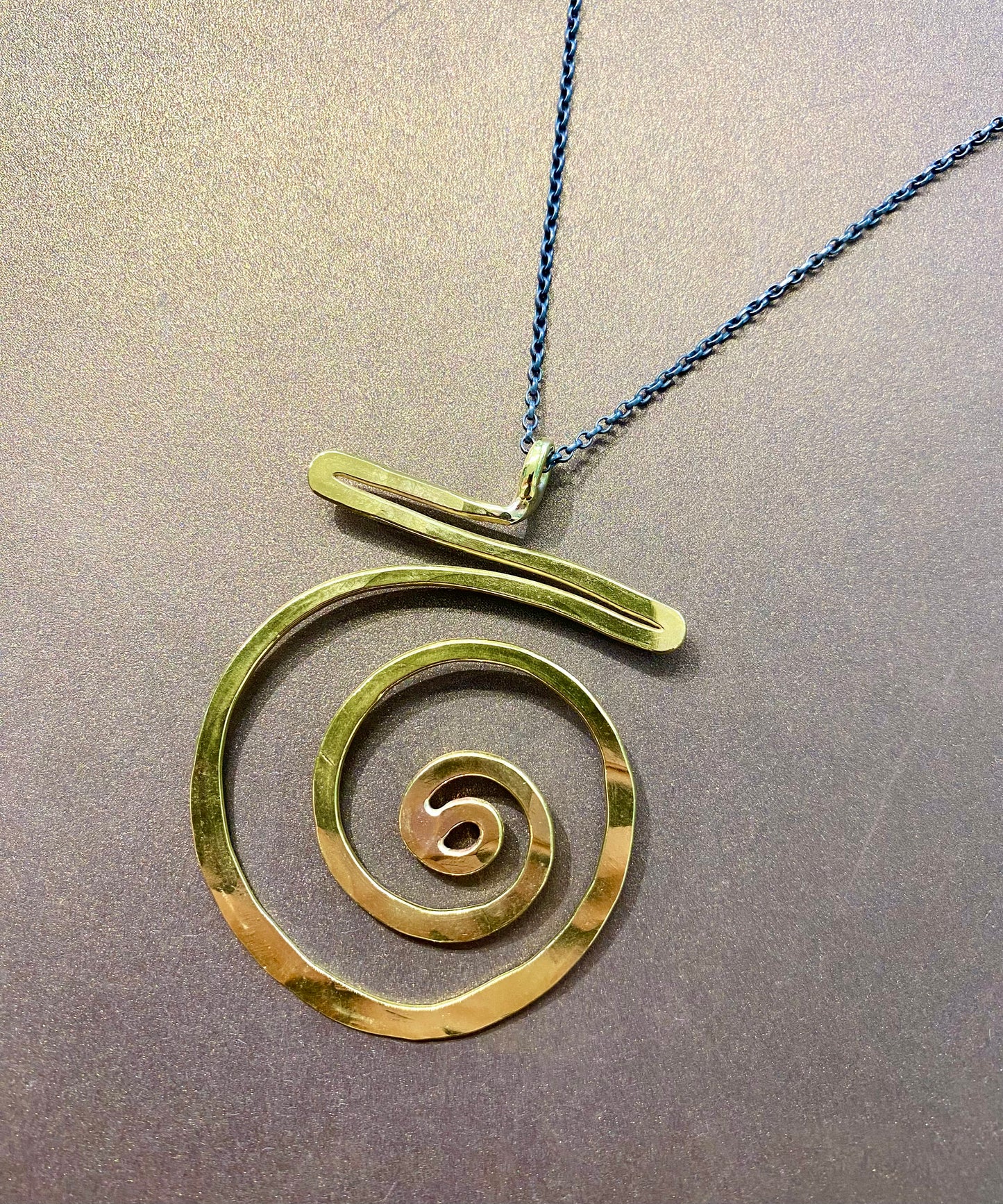 Brass swirl pendant